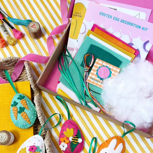 the contents of a cute and colourful easter egg decoration craft kit 