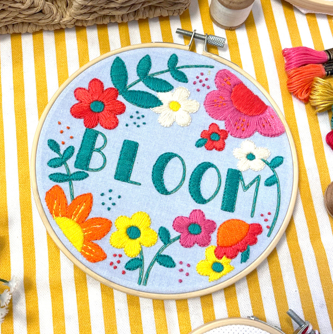 embroidery craft kit with a colourful floral design and the word 'bloom'