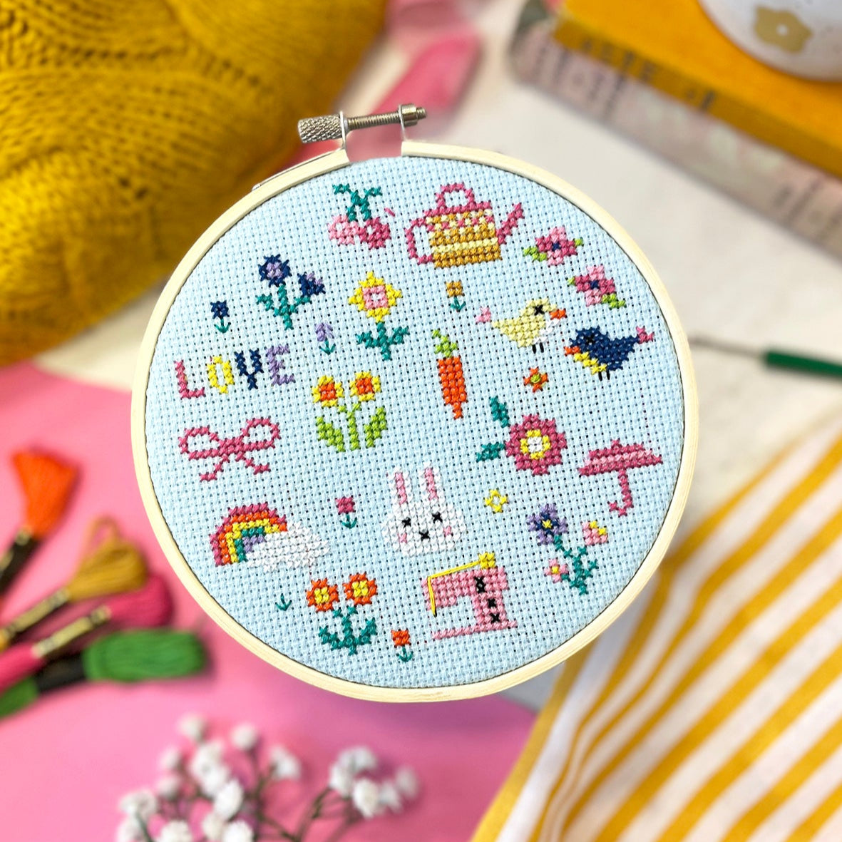 cross stitch hoop showing a selection of spring mini stitch designs