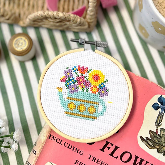 Cute watering can cross stitch design with florals 